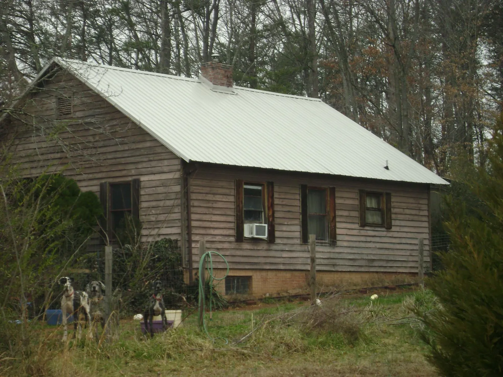 White metal roof on an old wood sided farmhouse, from a Metal Roof Installation job in South Prairie